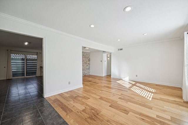 unfurnished room featuring wood-type flooring and ornamental molding