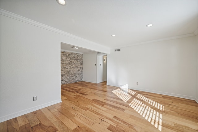 unfurnished room featuring light hardwood / wood-style floors and ornamental molding