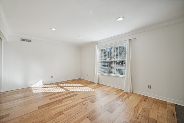 spare room with light hardwood / wood-style floors and ornamental molding