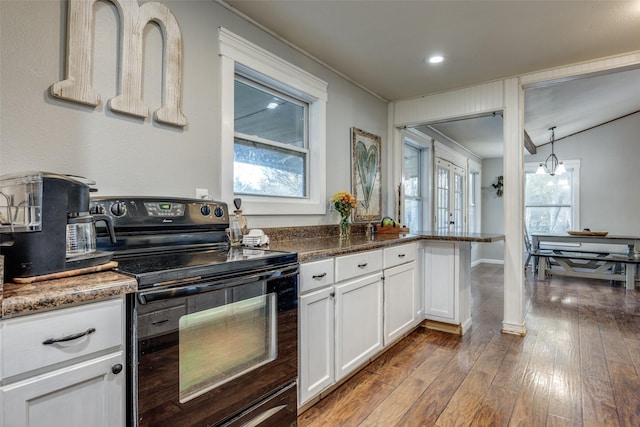 1347 Wild Rd, Van Alstyne, TX 75495 - kitchen featuring black electric range, white cabinetry, dark wood-style floors, recessed lighting, and dark stone countertops