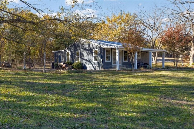 view of front of home with covered porch and a front yard