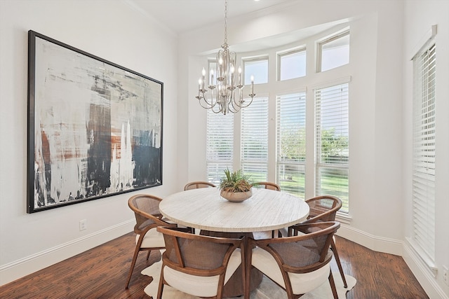 dining space with a notable chandelier, dark hardwood / wood-style flooring, and crown molding