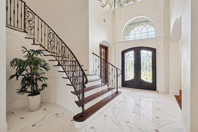 entrance foyer with french doors and a towering ceiling