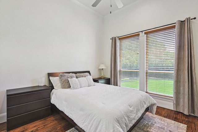 bedroom with dark hardwood / wood-style flooring, multiple windows, crown molding, and ceiling fan