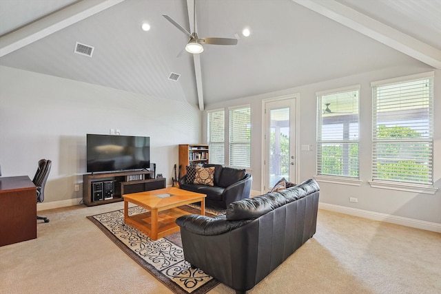 living room with a healthy amount of sunlight, light colored carpet, and beam ceiling