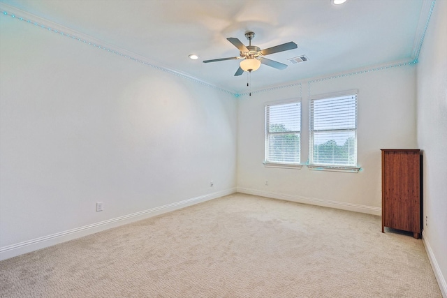 carpeted empty room with ceiling fan and ornamental molding