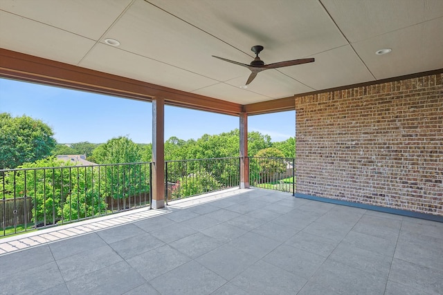 unfurnished sunroom with ceiling fan