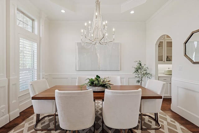 dining space featuring dark hardwood / wood-style floors and ornamental molding