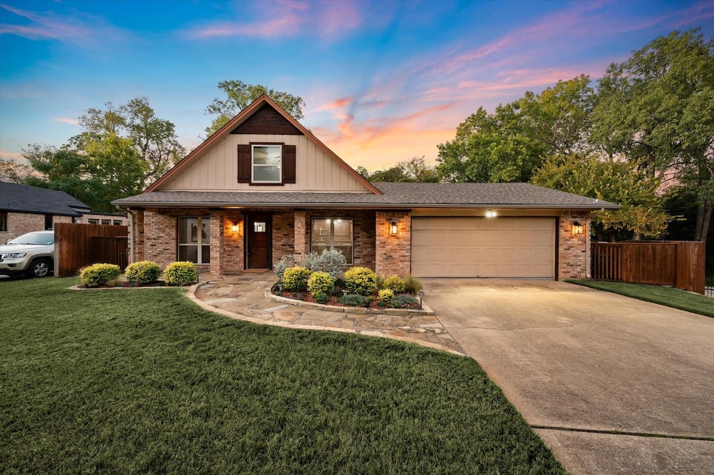 view of front facade with a yard and a garage