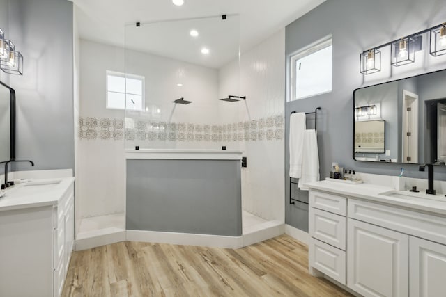 bathroom with hardwood / wood-style floors, vanity, and plenty of natural light