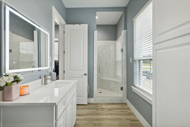 bathroom with vanity, hardwood / wood-style flooring, and an enclosed shower