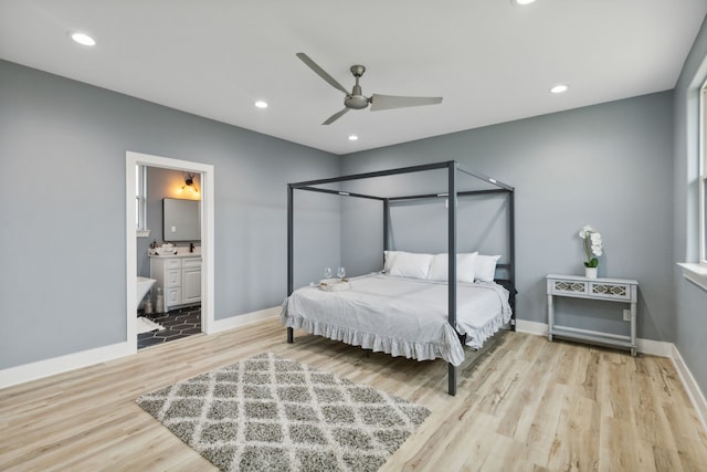 bedroom featuring light hardwood / wood-style floors, ensuite bath, and ceiling fan