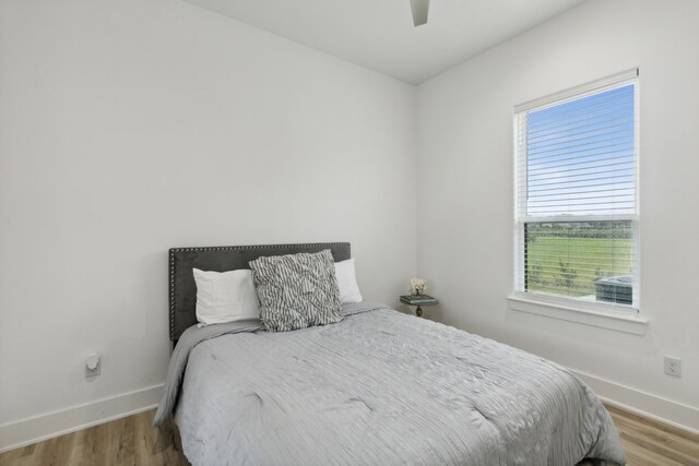 bedroom with hardwood / wood-style floors and ceiling fan