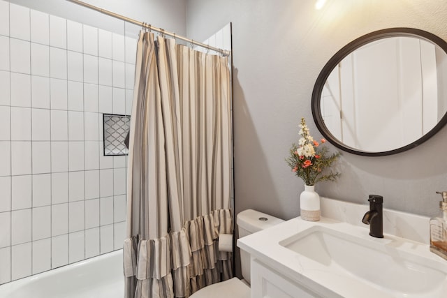 full bathroom featuring shower / bath combo, toilet, and vanity