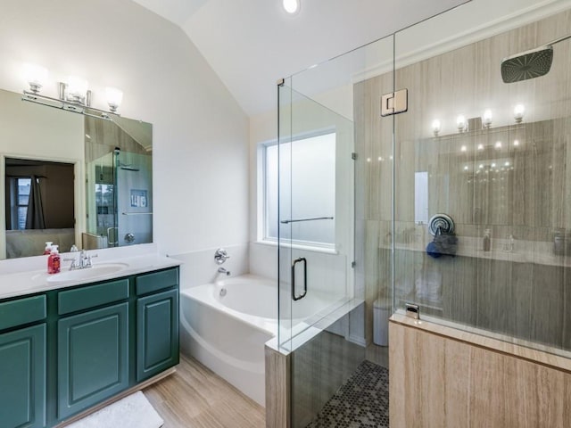 bathroom with vaulted ceiling, wood-type flooring, separate shower and tub, and vanity