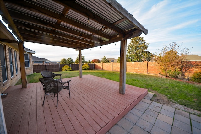 wooden deck featuring a lawn