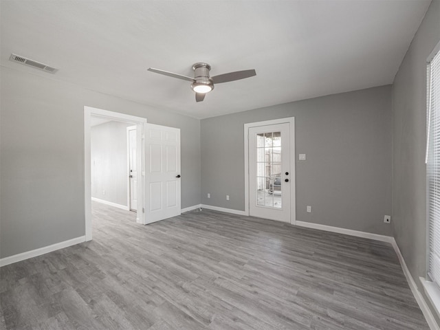 empty room featuring hardwood / wood-style floors and ceiling fan