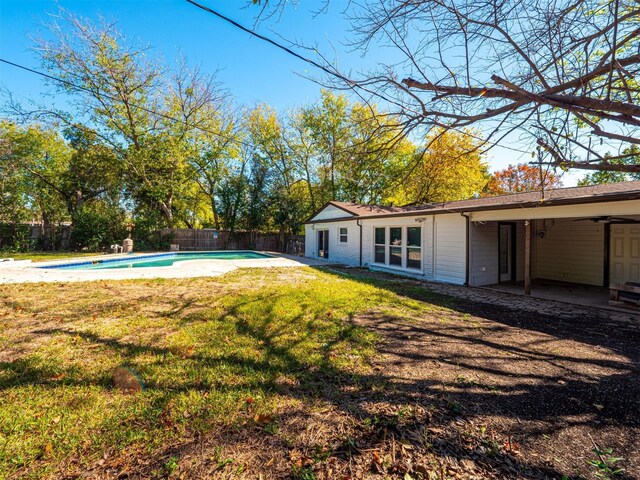 view of yard with a fenced in pool and a patio area