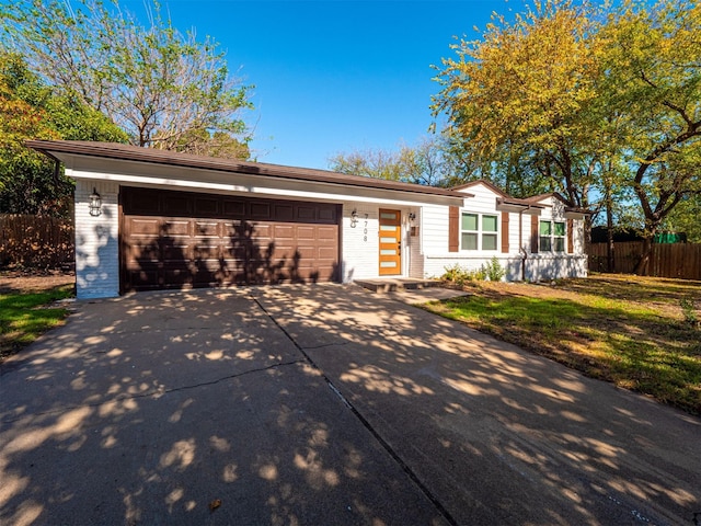 ranch-style house featuring a garage and a front yard