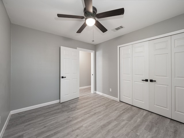 unfurnished bedroom with ceiling fan, a closet, and light hardwood / wood-style flooring