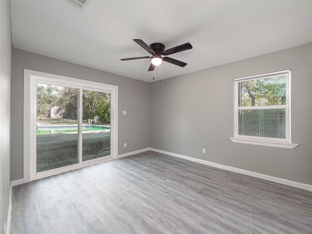 unfurnished room featuring hardwood / wood-style floors and ceiling fan