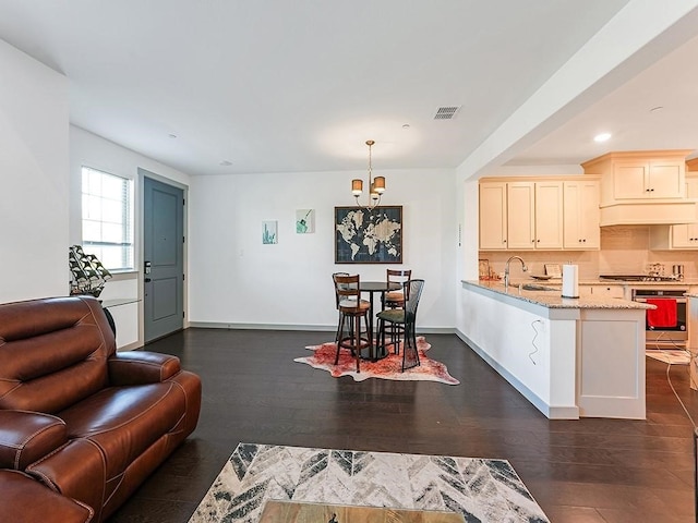 living room featuring dark hardwood / wood-style floors and sink