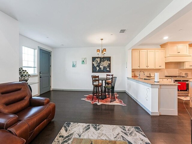 living room featuring dark hardwood / wood-style floors and sink