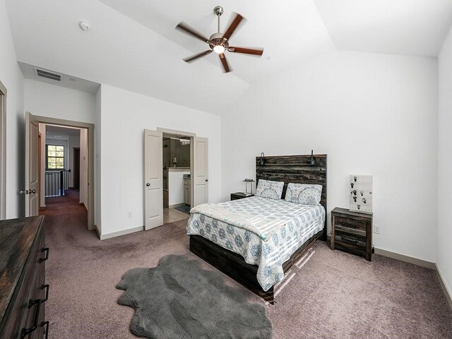 carpeted bedroom featuring connected bathroom, ceiling fan, and lofted ceiling