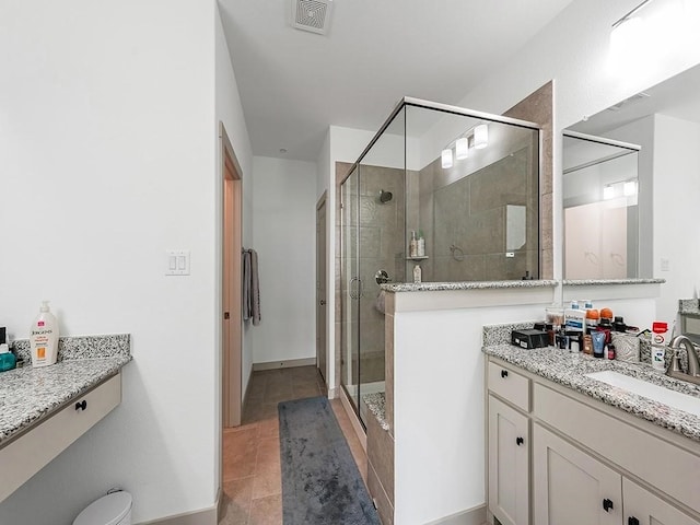 bathroom featuring vanity, tile patterned floors, and walk in shower