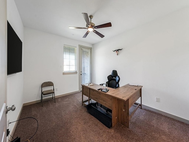 office space featuring dark colored carpet and ceiling fan