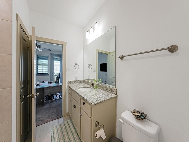 bathroom featuring ceiling fan, tile patterned flooring, vanity, and toilet