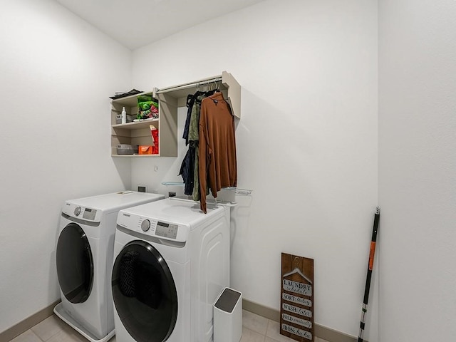 laundry area featuring light tile patterned floors and washing machine and clothes dryer