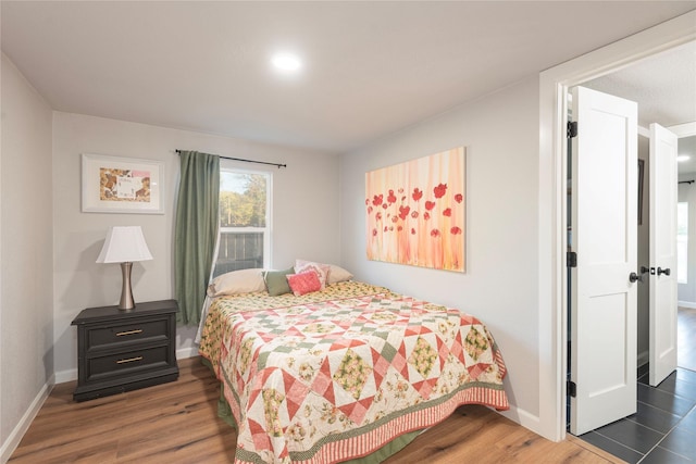 bedroom featuring dark wood finished floors and baseboards