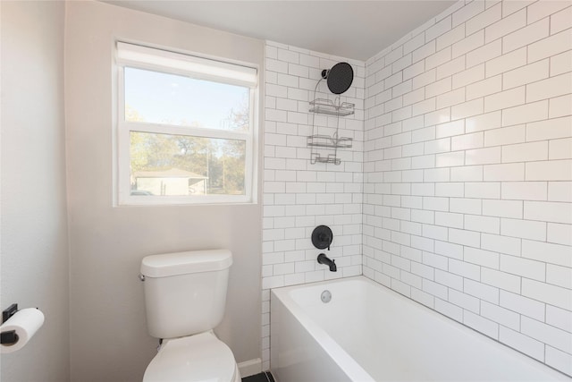 bathroom featuring shower / bathing tub combination and toilet