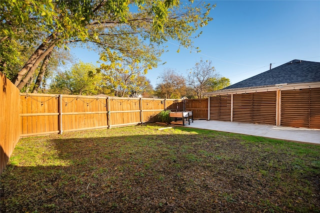 view of yard with a fenced backyard and a patio