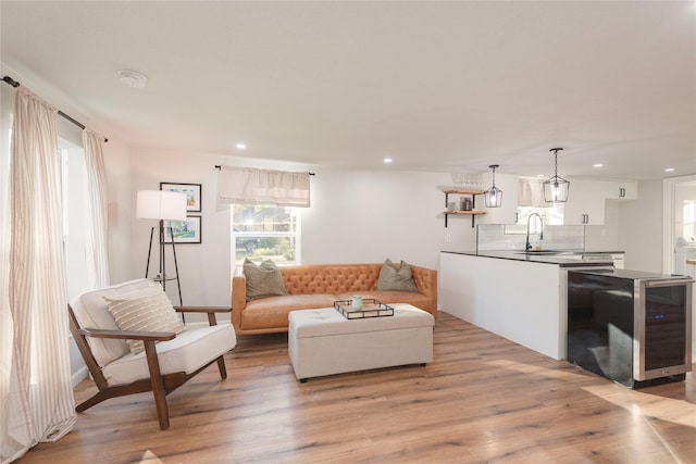 living area featuring light wood-type flooring and recessed lighting