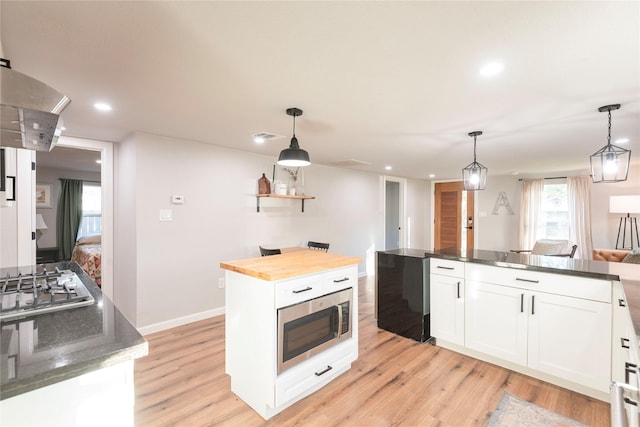 kitchen featuring appliances with stainless steel finishes, pendant lighting, and a kitchen island