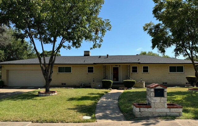 ranch-style house with a front lawn and a garage