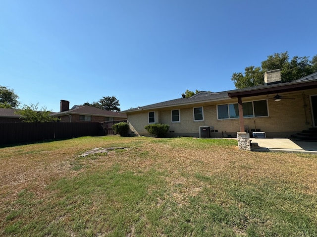 view of yard with ceiling fan, central air condition unit, and a patio