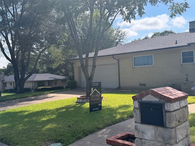 exterior space featuring a lawn and a garage