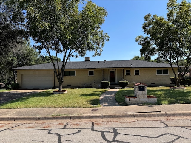 ranch-style house with a front yard and a garage