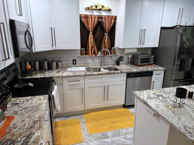 kitchen featuring white cabinets, sink, and appliances with stainless steel finishes