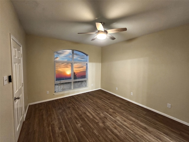 spare room featuring ceiling fan and dark hardwood / wood-style flooring