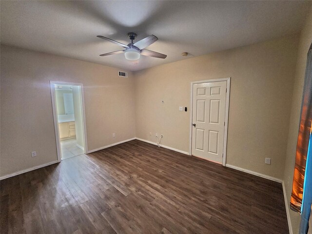 unfurnished room featuring ceiling fan and dark hardwood / wood-style flooring