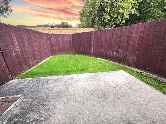 yard at dusk with a patio