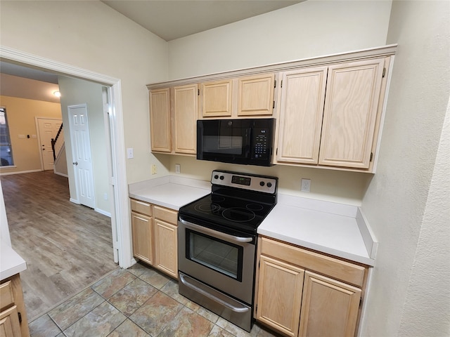 kitchen featuring light brown cabinetry, light hardwood / wood-style flooring, and stainless steel electric stove