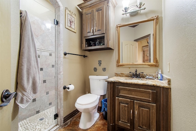 bathroom featuring vanity, toilet, and an enclosed shower