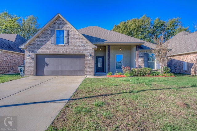 view of front of property with a front yard and a garage