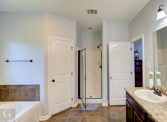 bathroom featuring tile patterned floors, vanity, and separate shower and tub