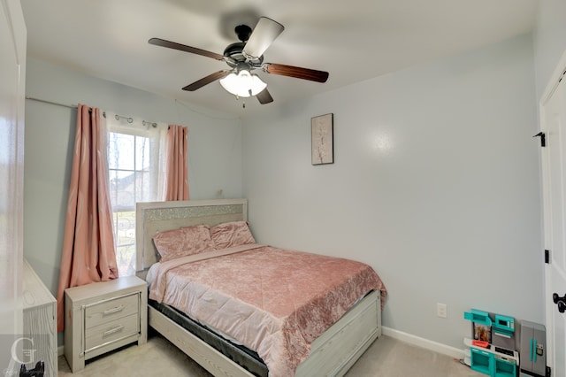 bedroom featuring light colored carpet and ceiling fan